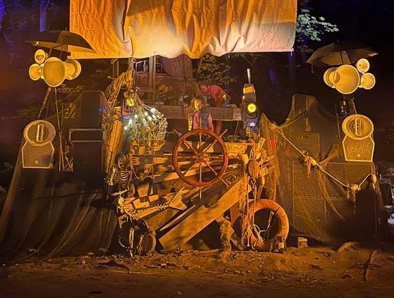 The ship stage lit warm at night, with Void horns hanging at both sides